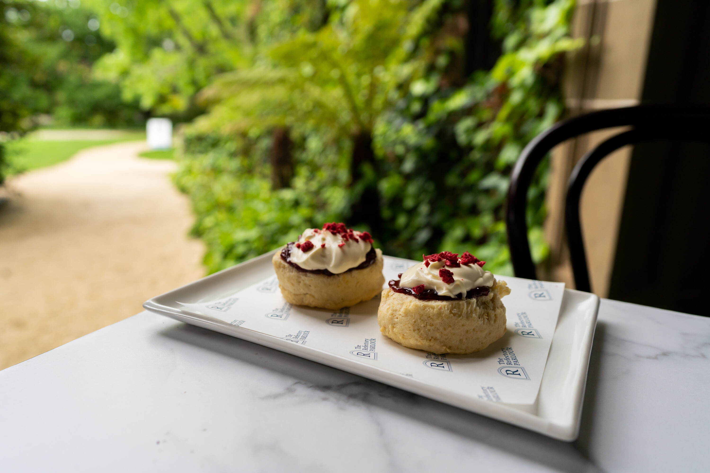 scones on a table with greenery in the background