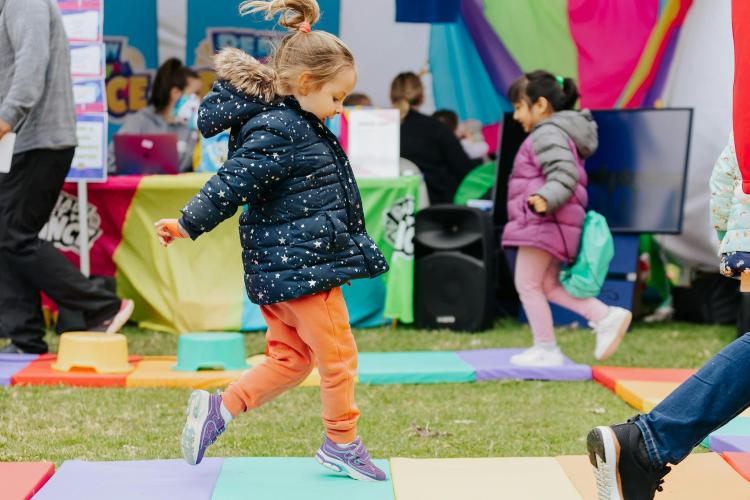 a child jumping on padded mats in the Active Kids Zone