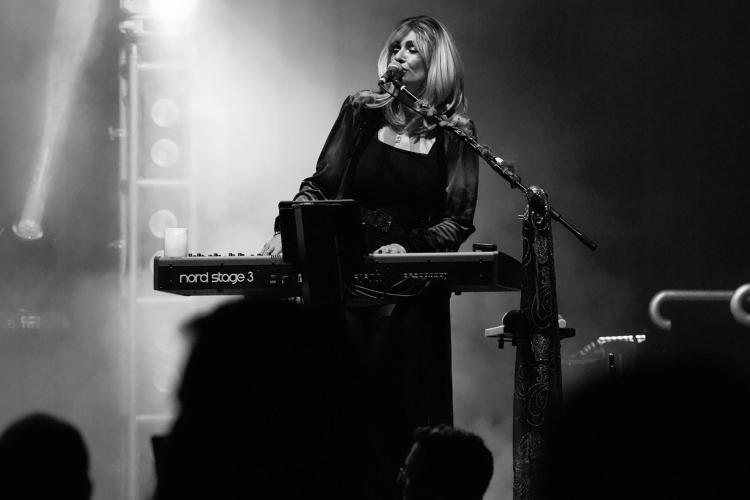 Former Dreams Show members performing Fleetwood Mac hits onstage with full crowd energy.