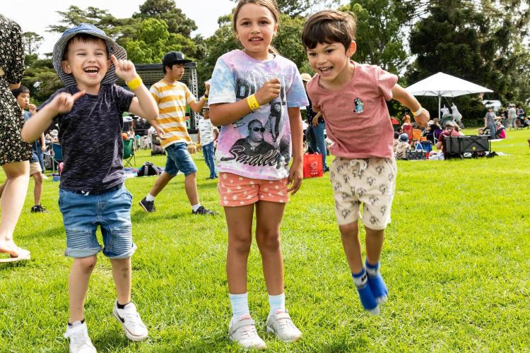 Three children jumping into the air