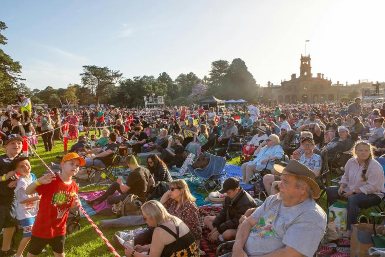 crowd seated in front of Werribee Park Mansion
